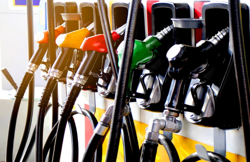 A row of fuel nozzles next to each other at a gas station
