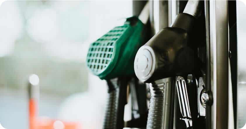 A close up of 2 fuel nozzles at a pump