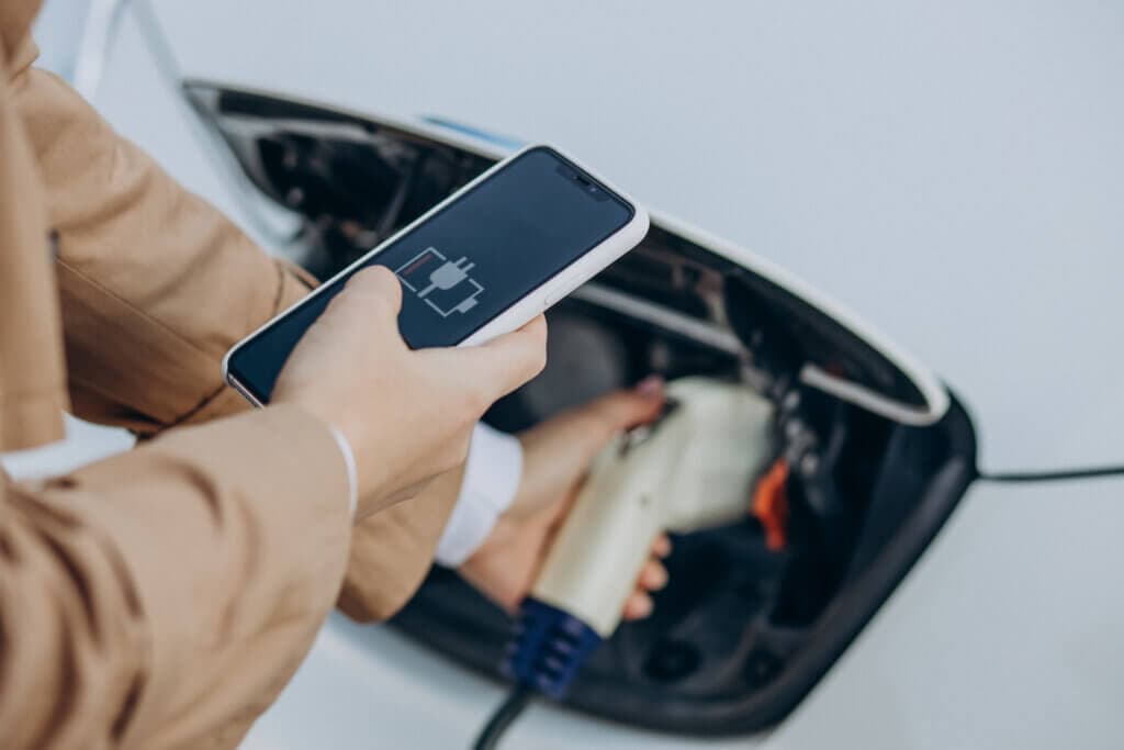 Someone that uses a mobile phone while charging their car
