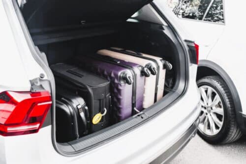 A set of suitcases in the trunk of a car